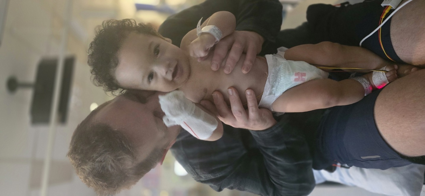 First cuddles with Dad after surgery. Chest bandage and all.